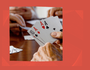 red square with picture of hands holding playing cards